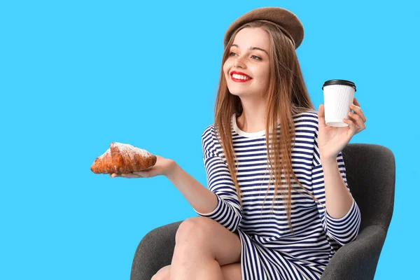 Young Woman Croissant Cup Coffee Sitting Armchair Blue Background — Stock Photo, Image