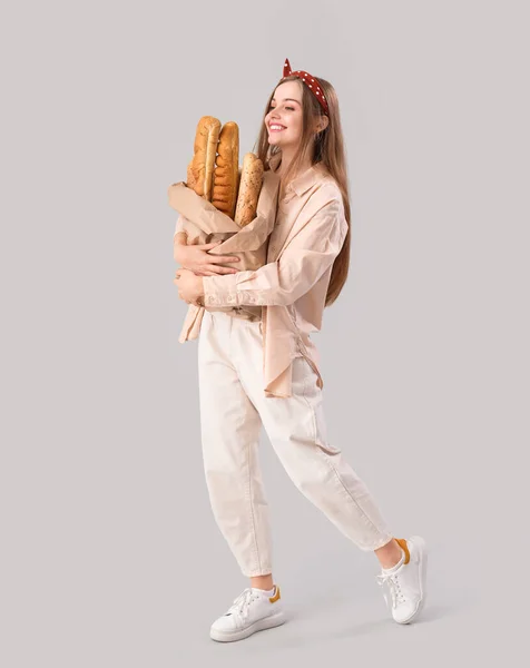 Young Woman Fresh Baguettes Grey Background — Stock Photo, Image