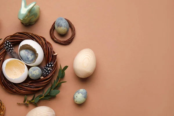 Composition with Easter eggs, shells, bunny and eucalyptus branch on color background