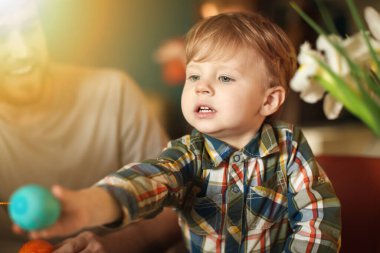 Cute little boy with Easter egg at home