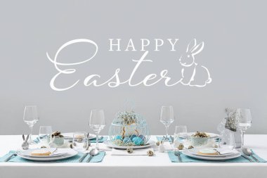 Greeting card with beautiful Easter table setting on grey background