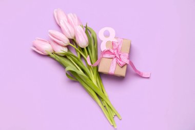 Bouquet of beautiful tulip flowers and gift for Women's Day celebration on lilac background. Women's Day celebration