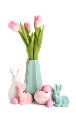 Vase with tulip flowers, bunnies and Easter eggs on white background