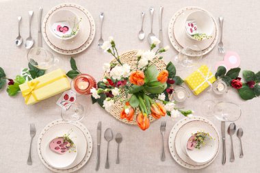 Setting for International Women's Day celebration with flowers and gift boxes on table