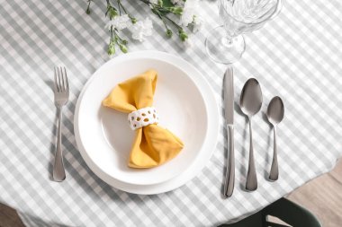 Setting for International Women's Day celebration with cutlery and napkin on table