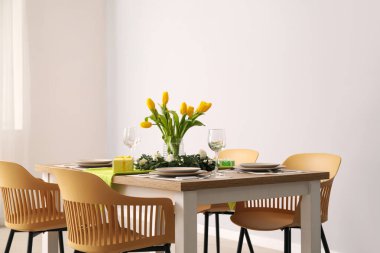 Table setting for International Women's Day celebration with gifts and tulip flowers in light room