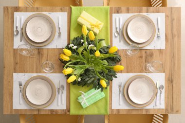 Setting for International Women's Day celebration with flowers and gifts on table