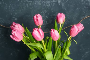 Beautiful tulip flowers on black grunge background