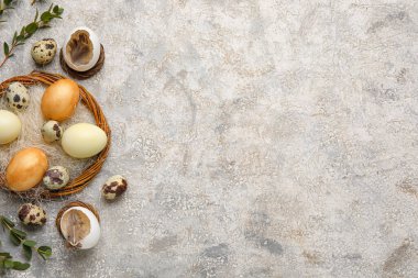 Easter eggs with wreath and plant branches on grunge background