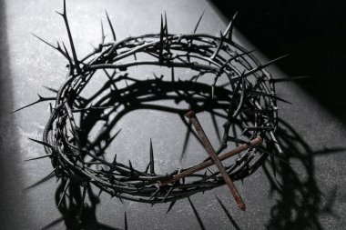 Crown of thorns with nails on dark background. Good Friday concept