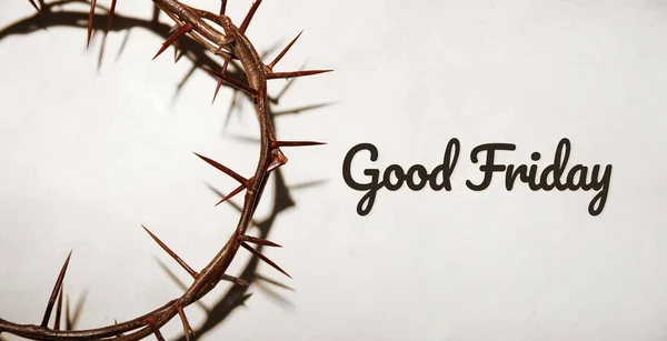 Crown of thorns and text GOOD FRIDAY on light background