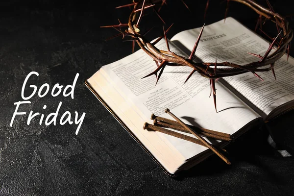 Crown of thorns with Holy Bible, nails and text GOOD FRIDAY on dark background