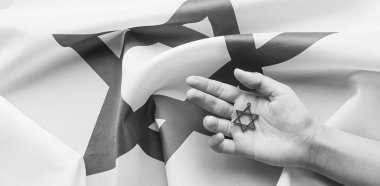 Hand with star of David on flag of Israel. Black and white effect