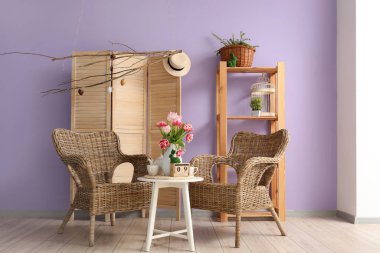 Vase with tulips, Easter bunny and teapot on end table in living room
