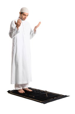 Praying Muslim man on white background