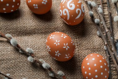 Napkin with painted Easter eggs and willow branches, closeup