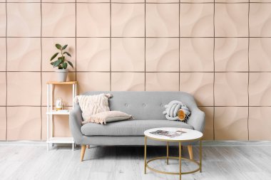 Interior of living room with grey couch and shelving unit