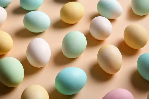 Composition with painted and natural Easter eggs on color background