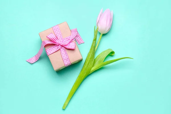 Beautiful tulip flower and gift for Women\'s Day celebration on color background