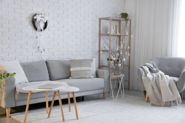 Interior of living room with Easter wreath and sofa