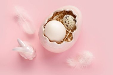 Decorative shell with Easter eggs and bunny on pink background