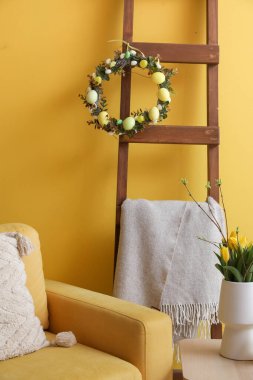 Ladder with Easter wreath and plaid in living room