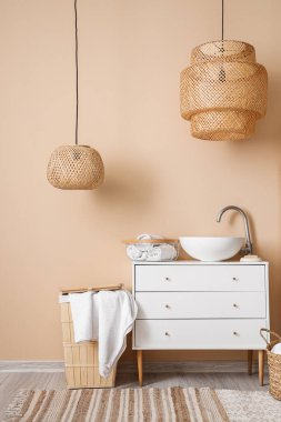 Interior of bathroom with sink, drawers and basket