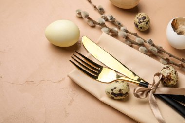 Table serving with Easter eggs and pussy willow branches on brown grunge background, closeup