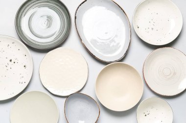 Composition with clean ceramic plates on white background