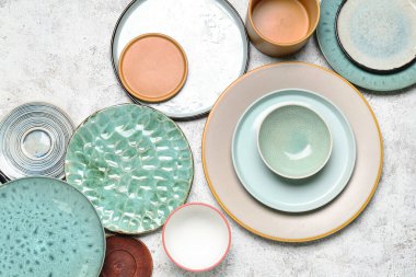 Composition with clean ceramic plates and bowls on white background