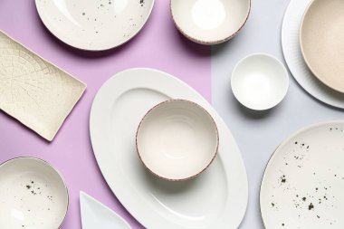 Composition with clean dishes on lilac and grey background
