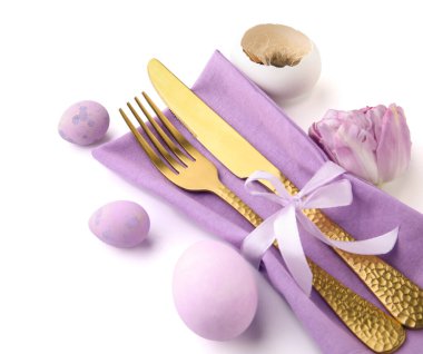 Cutlery with Easter eggs and tulip flower isolated on white background