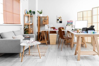 Interior of atelier with tailor's workplace and sofa