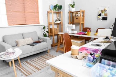 Interior of atelier with tailor's workplace and sofa