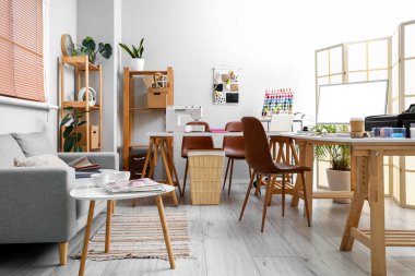 Interior of atelier with tailor's workplace and sofa