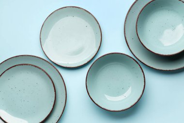 Set of plates on blue background