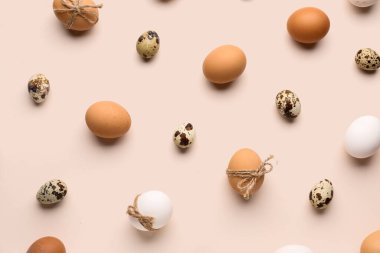 Different Easter eggs on pink background