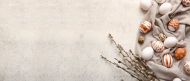 Beautiful Easter eggs and pussy willow branches on light background with space for text