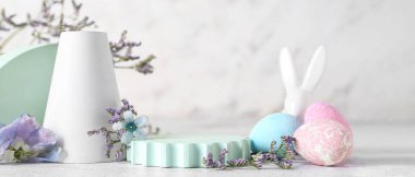 Empty podiums with spring flowers, Easter eggs and bunny on light background clipart