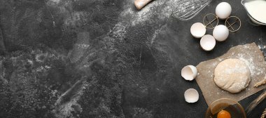 Ingredients for preparing bakery on dark background with space for text