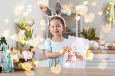 Cute little girl with painted Easter cakes on paper sheet in kitchen at home