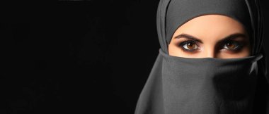 Beautiful Muslim woman on dark background, closeup. Banner for design
