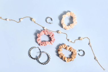 Composition with beautiful accessories and scrunchies on color background