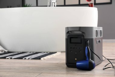 Portable power station with hair dryer in bathroom