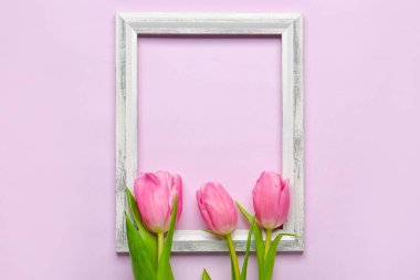 Composition with empty picture frame and beautiful tulip flowers on lilac background