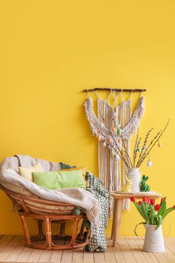Interior of living room with Easter decor, armchair and table