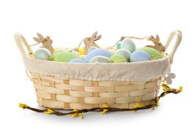 Basket with painted Easter eggs and decor on white background