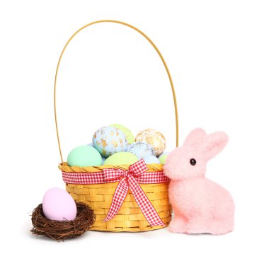 Wicker basket with painted Easter eggs and bunny isolated on white background