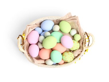 Wicker basket with painted Easter eggs isolated on white background