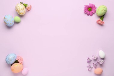 Composition with painted Easter eggs and spring flowers on color background
